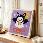 Bat costume ghost punch needle artwork displayed on a table