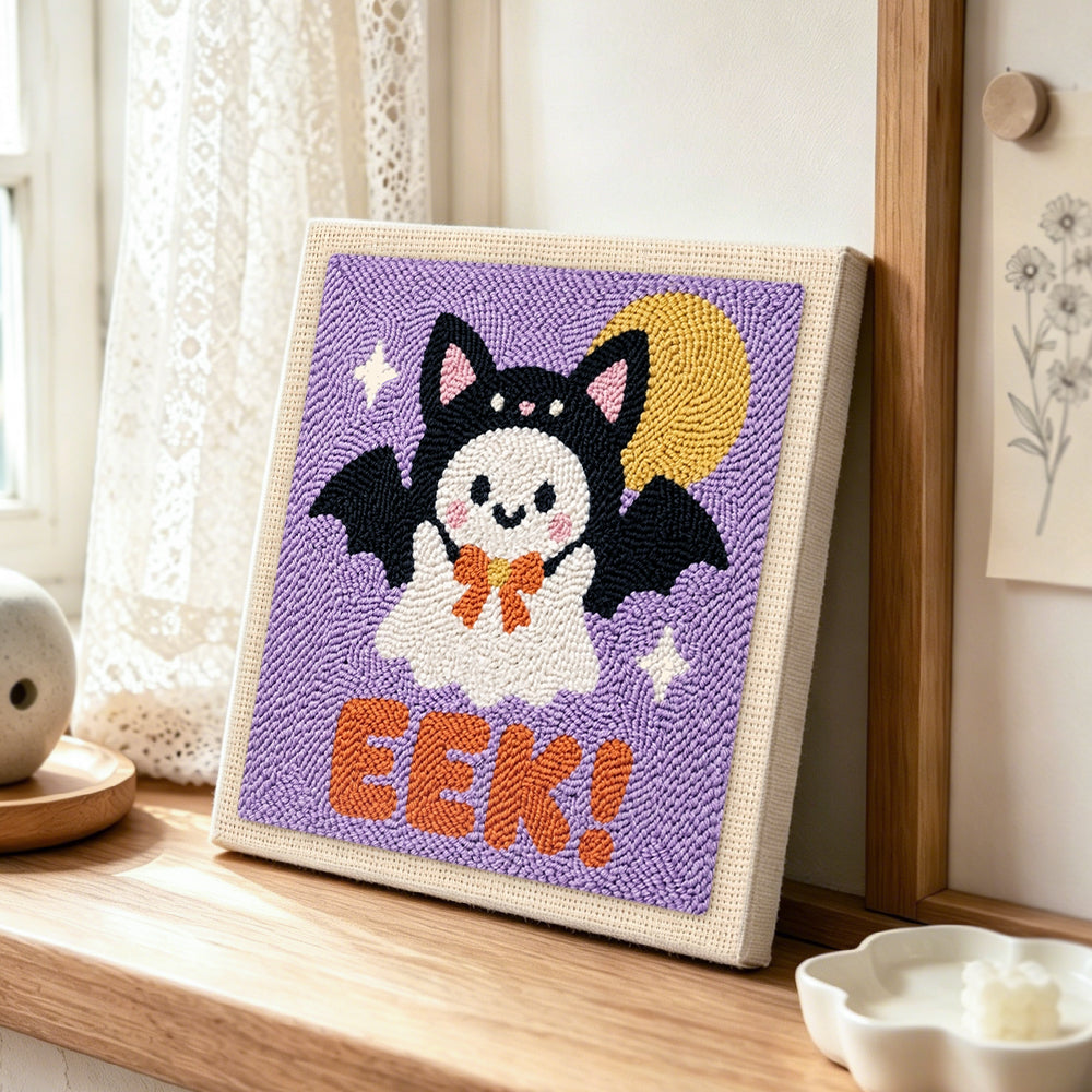 Bat costume ghost punch needle artwork displayed on a table