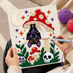 Creating handmade bat hanging under mushroom punch needle artwork