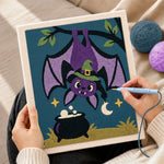 Creating handmade bat hanging upside‑down punch needle artwork