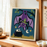 Bat hanging upside‑down punch needle artwork displayed on a table