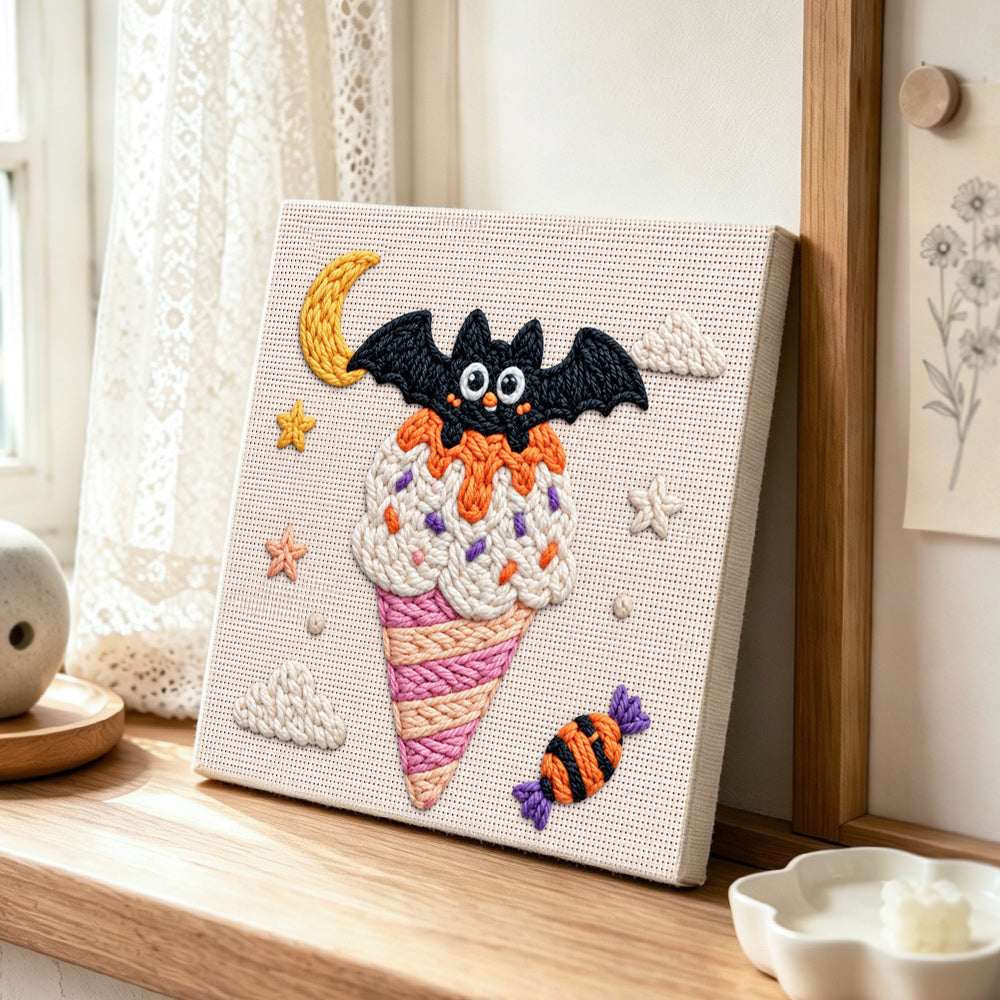 Bat moon ice cream punch needle artwork displayed on a table