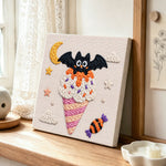 Bat moon ice cream punch needle artwork displayed on a table