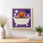 Finished bath time jack‑o‑lantern artwork displayed on a wall
