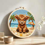 Beach highland cow punch needle artwork displayed on a table