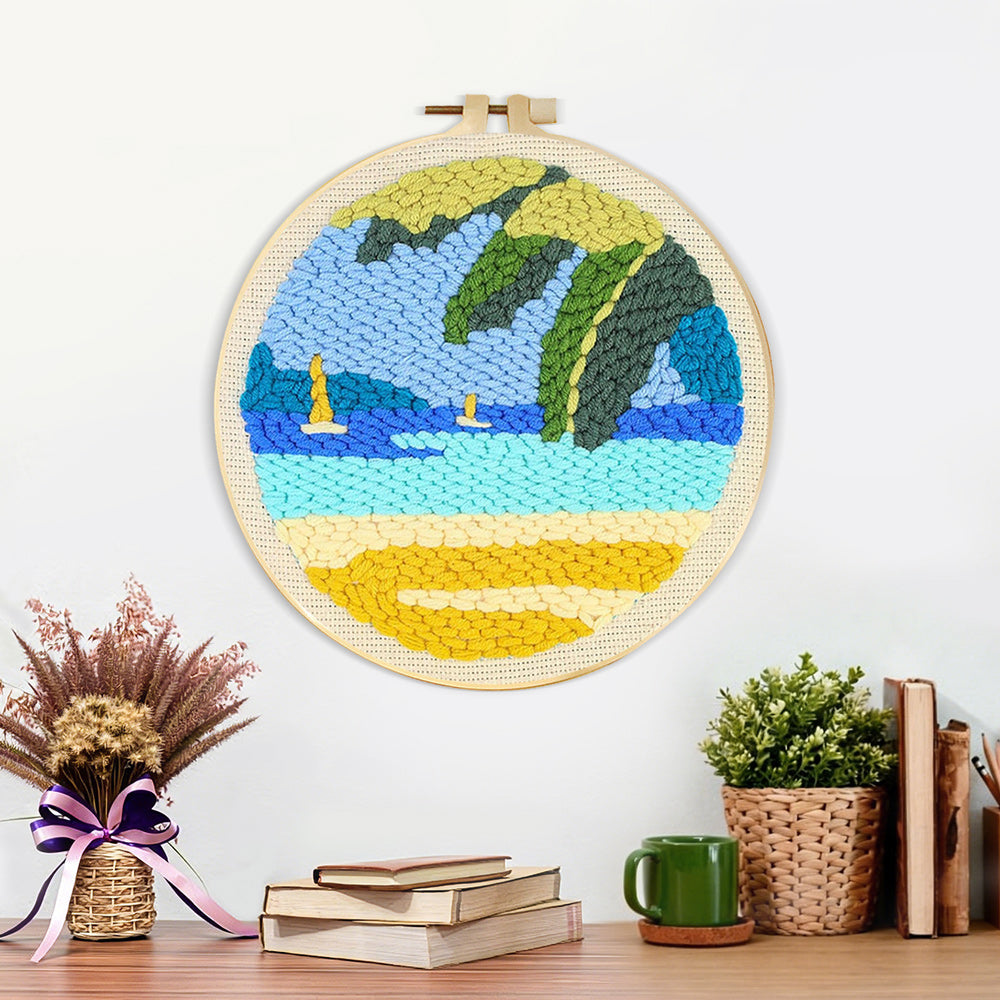 Finished beach with sailboats and tropical leaves artwork displayed on a wall