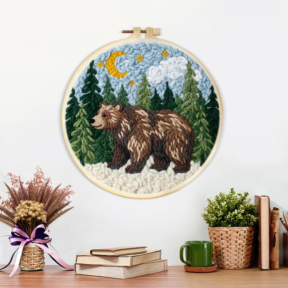 Finished bear in forest under moonlight artwork displayed on a wall