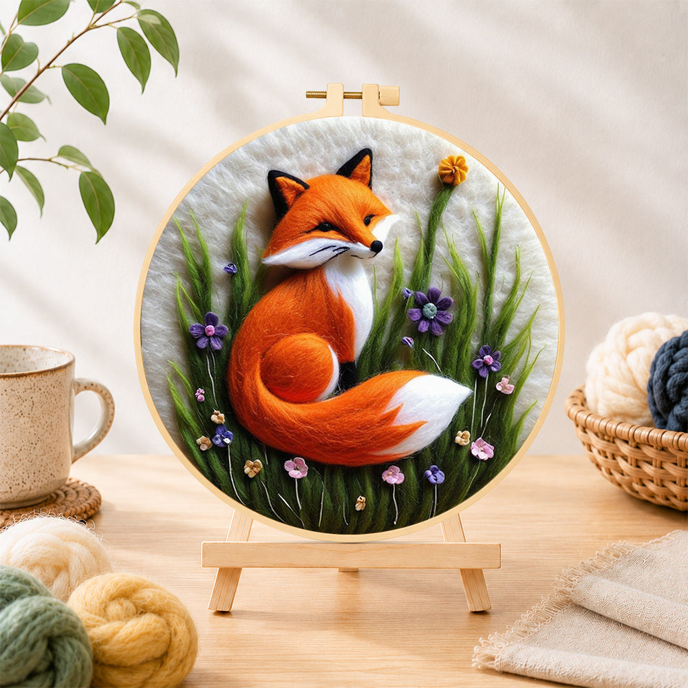 Finished beautiful red fox and purple wild flowers needle felting displayed on a wooden easel