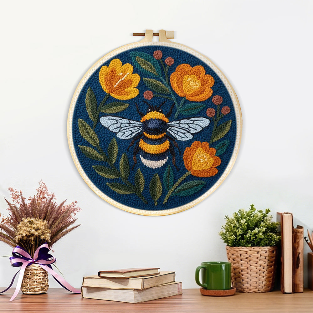 Finished bee and orange flowers artwork displayed on a wall
