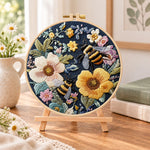 Bees in vintage florals embroidery kit finished hoop displayed on a wooden stand as cozy tabletop decor