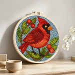 Berry cardinal punch needle artwork displayed on a table