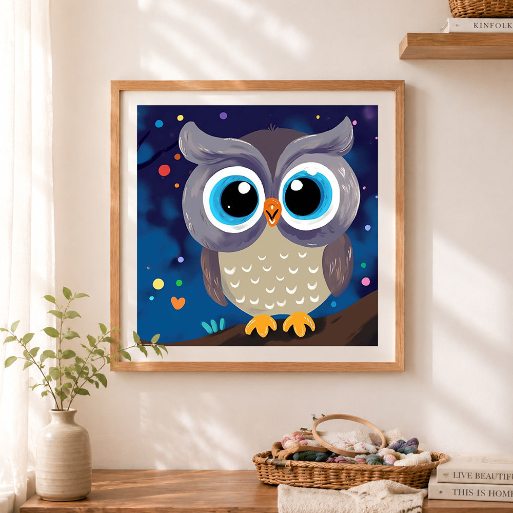 Finished big‑eyed night owl cross stitch artwork displayed as home decor