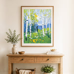Finished birch forest in blue and green cross stitch artwork displayed as home decor