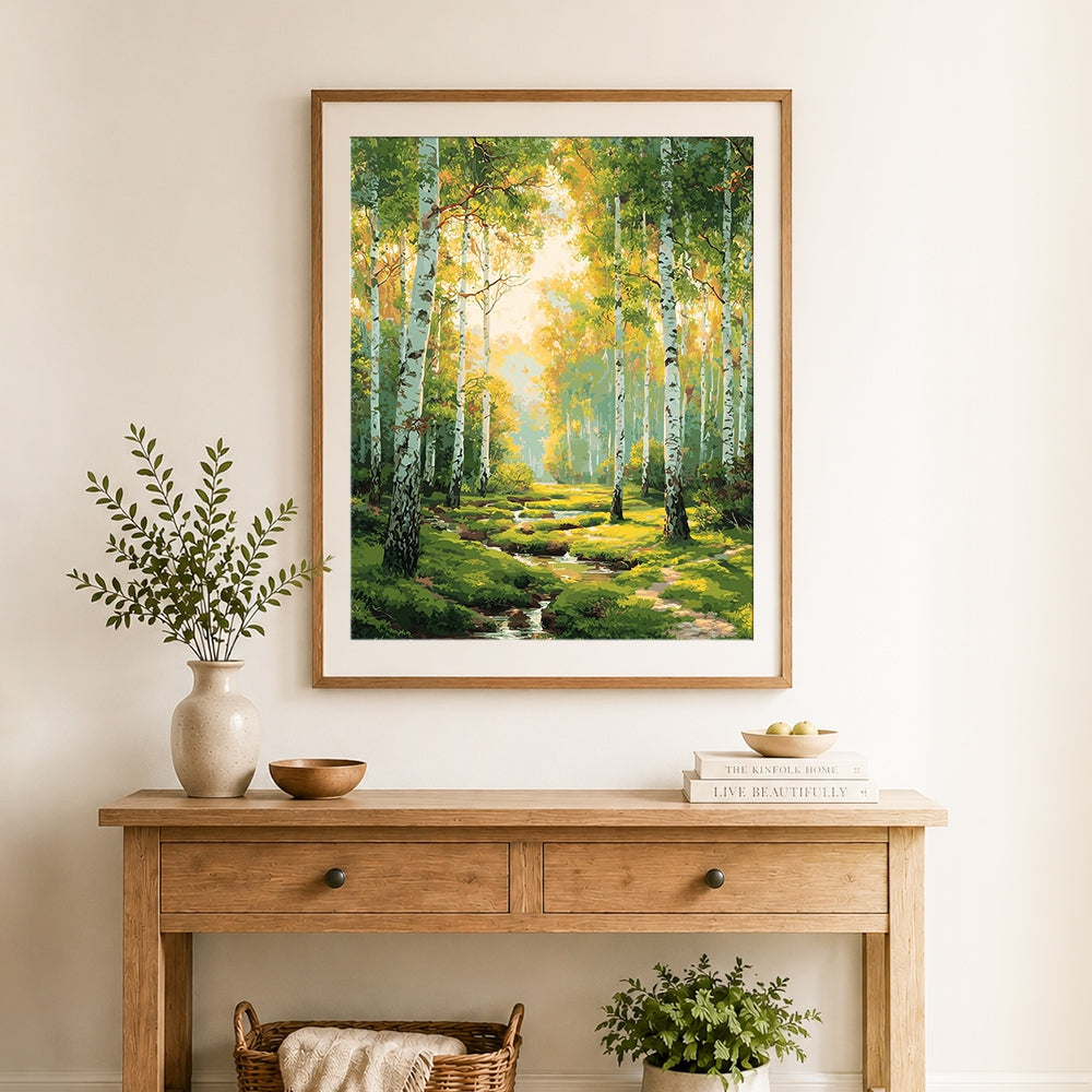 Finished birch trees along forest stream cross stitch artwork displayed as home decor