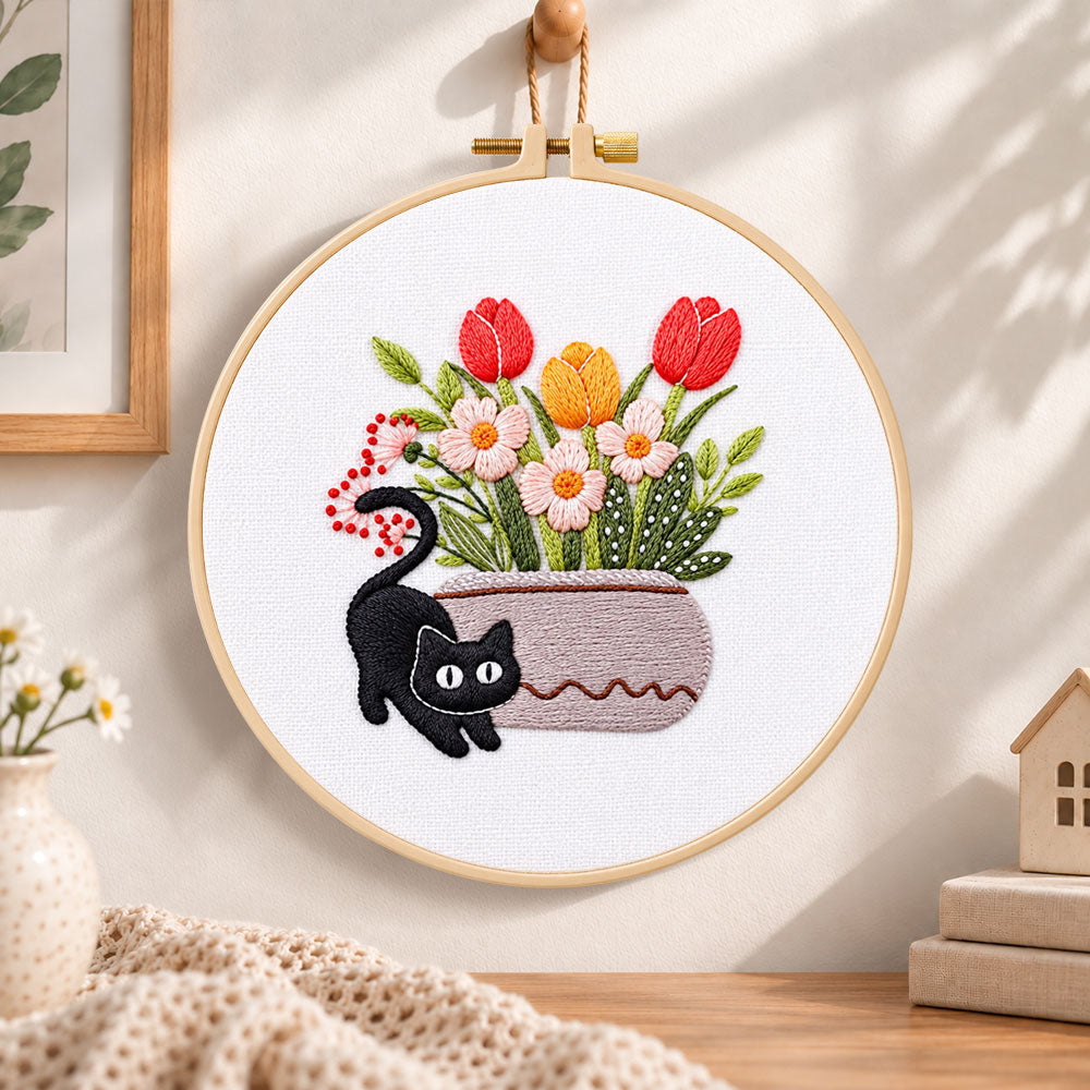 Black cat and tulips embroidery hoop wall art displayed as warm and cozy handmade home decor