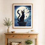 Finished black cat beneath the big moon cross stitch artwork displayed as home decor
