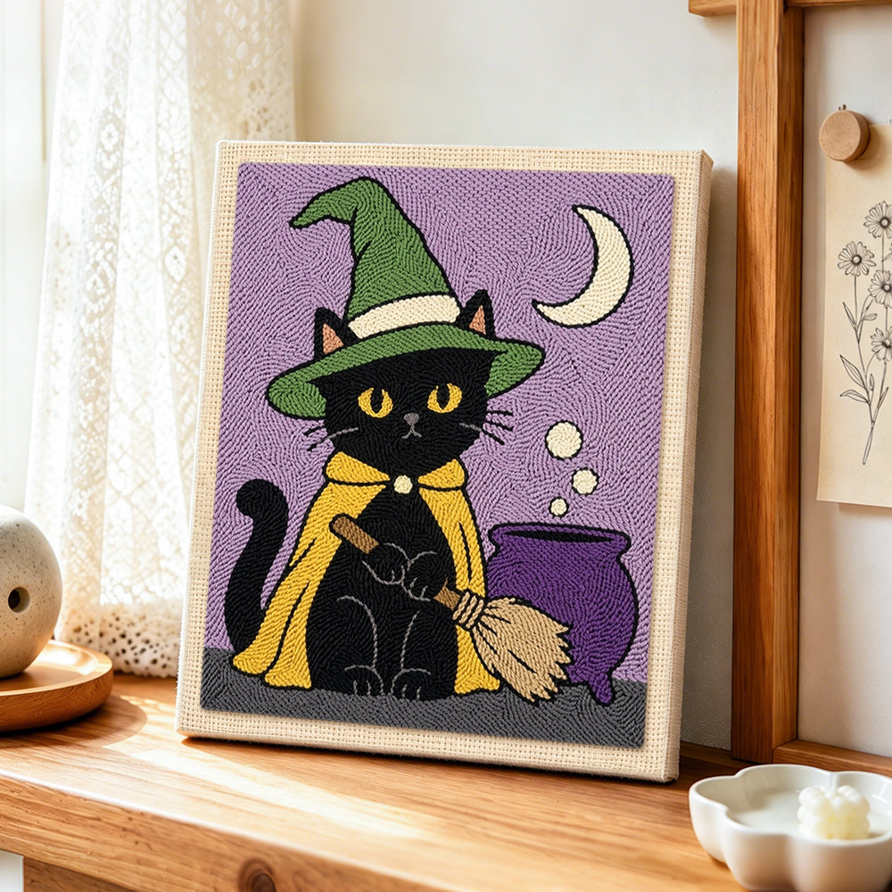 Black cat by magic cauldron punch needle artwork displayed on a table