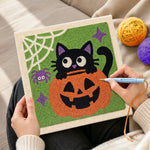 Creating handmade black cat in pumpkin punch needle artwork