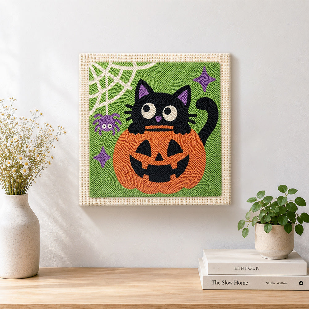 Finished black cat in pumpkin artwork displayed on a wall