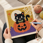 Creating handmade black cat on pumpkin punch needle artwork
