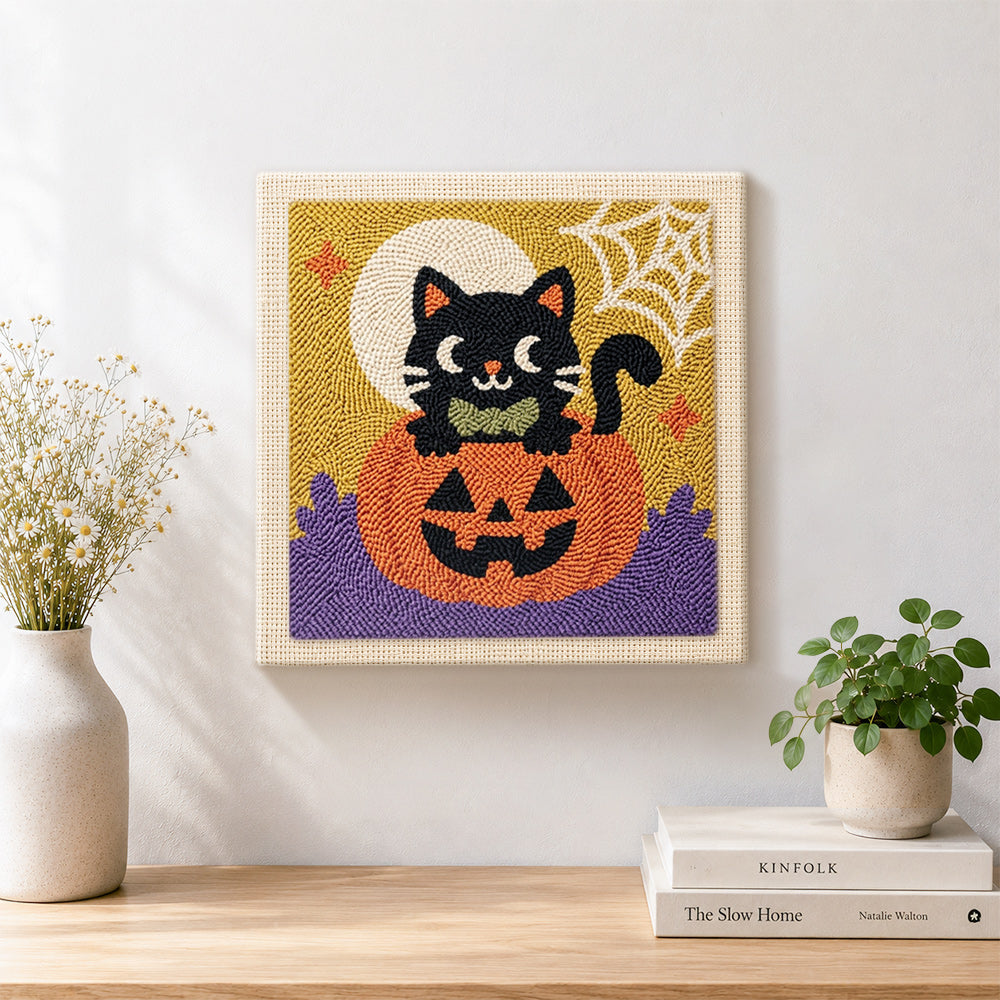Finished black cat on pumpkin artwork displayed on a wall