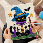 Creating handmade black cat reading magic book punch needle artwork