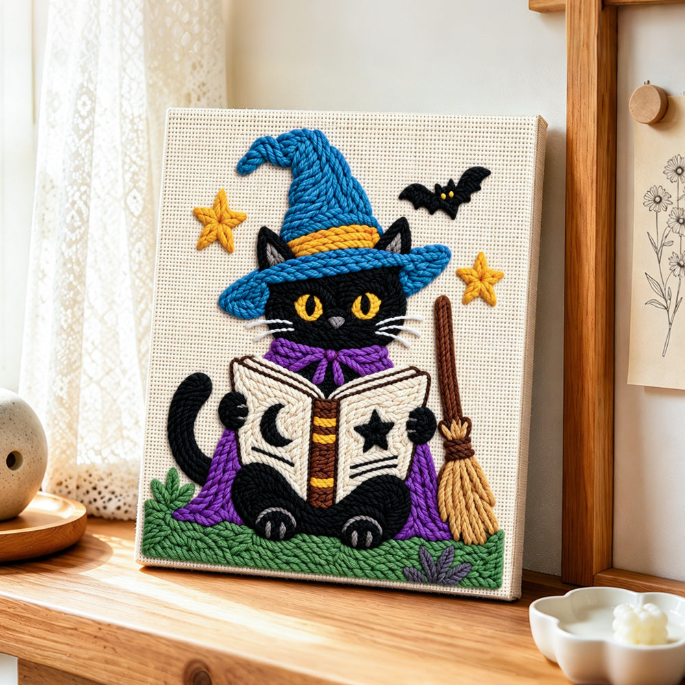 Black cat reading magic book punch needle artwork displayed on a table