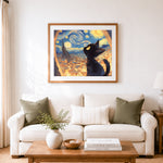 Finished black cat silhouette looking at starry night cross stitch artwork displayed as home decor