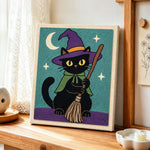 Black cat with broom punch needle artwork displayed on a table