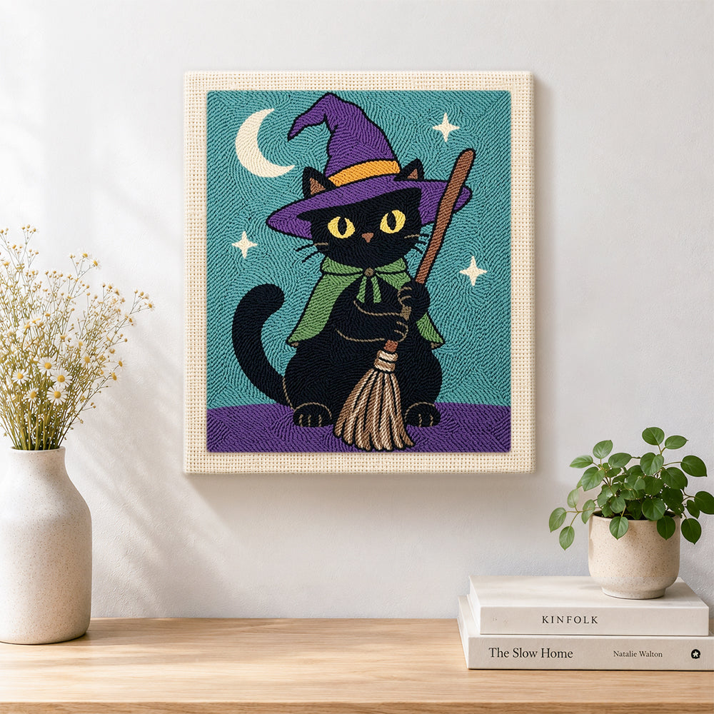 Finished black cat with broom artwork displayed on a wall