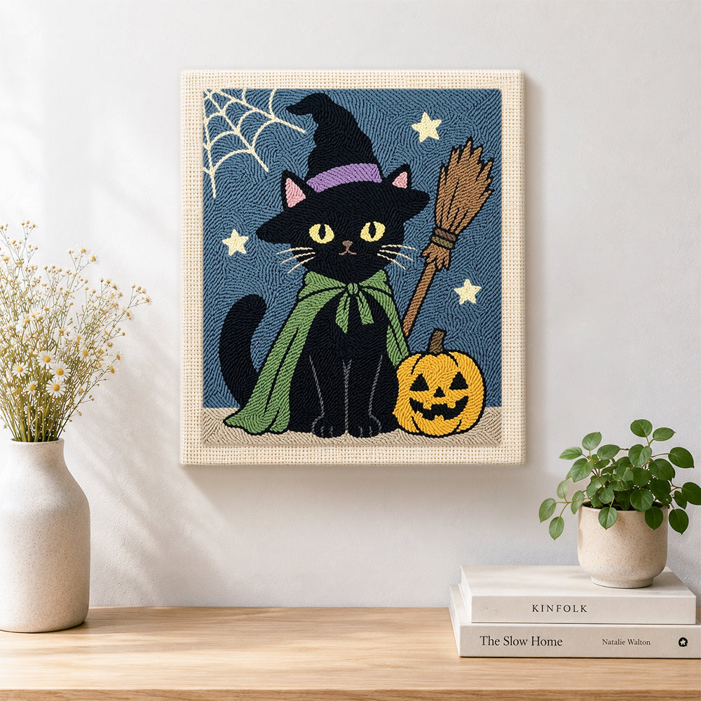 Finished black cat with pumpkin artwork displayed on a wall