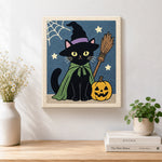 Finished black cat with pumpkin artwork displayed on a wall