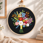 Black fabric flower bouquet embroidery hoop wall art displayed as warm and cozy handmade home decor