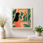 Finished black hair woman, tropical leaves and framed banana artwork displayed on a wall