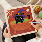 Creating handmade black witch cat in cauldron punch needle artwork