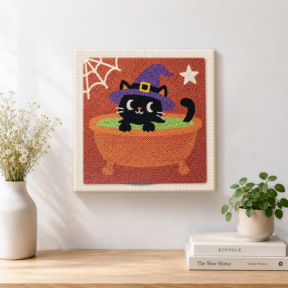 Finished black witch cat in cauldron artwork displayed on a wall