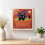 Finished black witch cat in cauldron artwork displayed on a wall