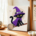 Black witch cat on broomstick punch needle artwork displayed on a table