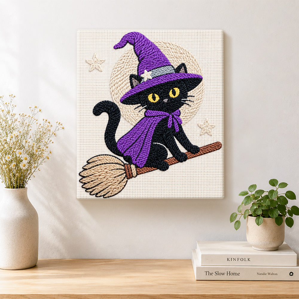 Finished black witch cat on broomstick artwork displayed on a wall