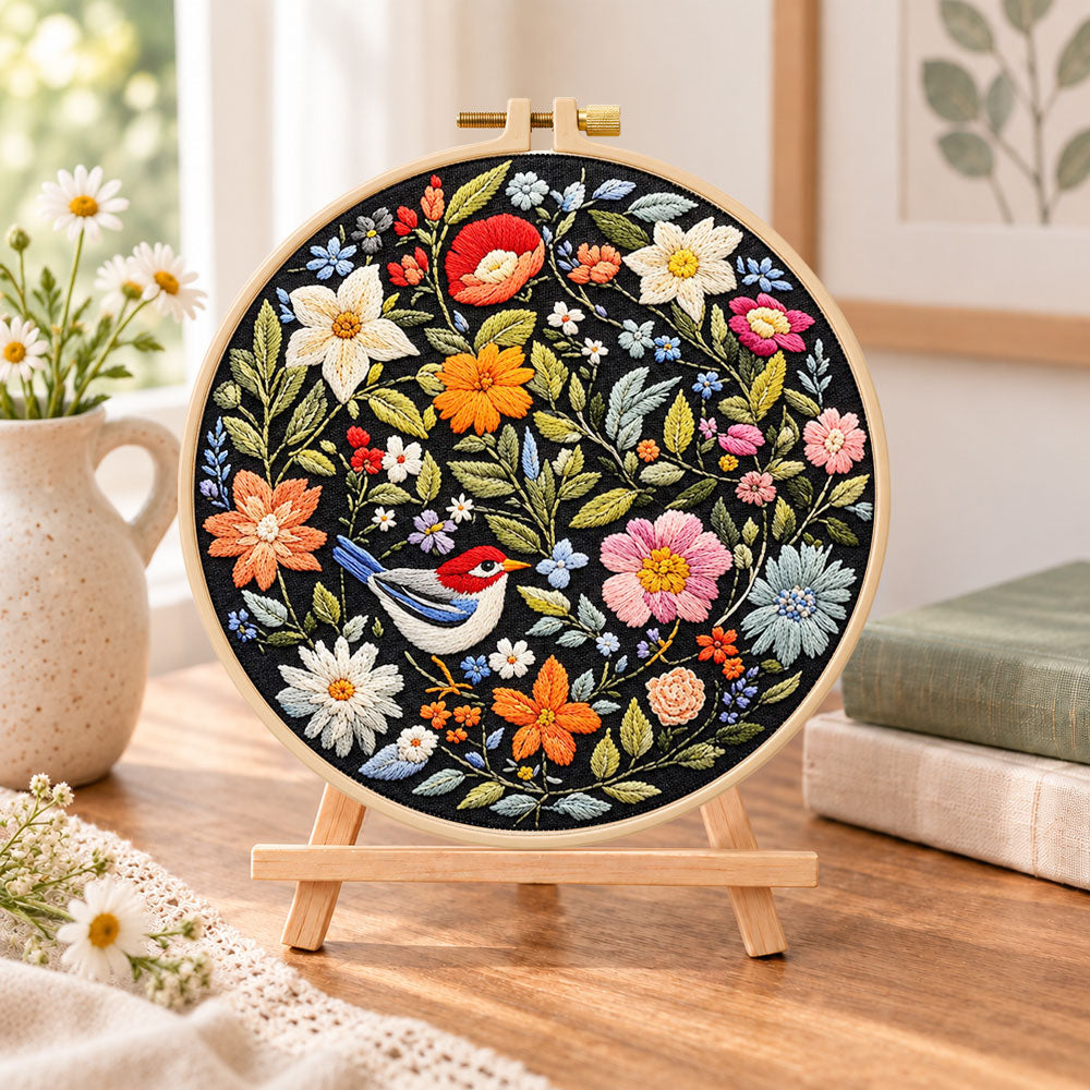Blossom and bird art embroidery kit finished hoop displayed on a wooden stand as cozy tabletop decor