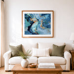 Finished blue and gold abstract fluid art cross stitch artwork displayed as home decor