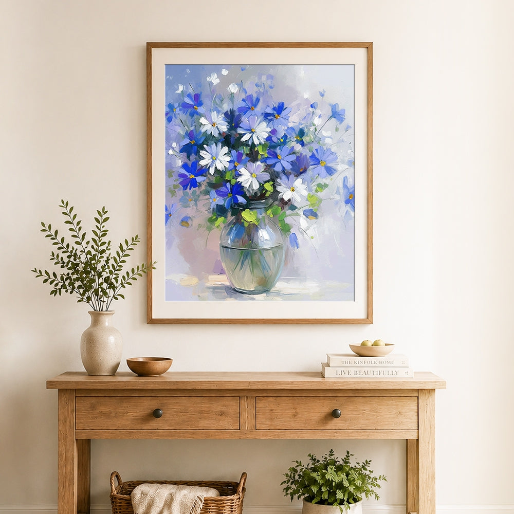 Finished blue and white wildflowers in round vase cross stitch artwork displayed as home decor