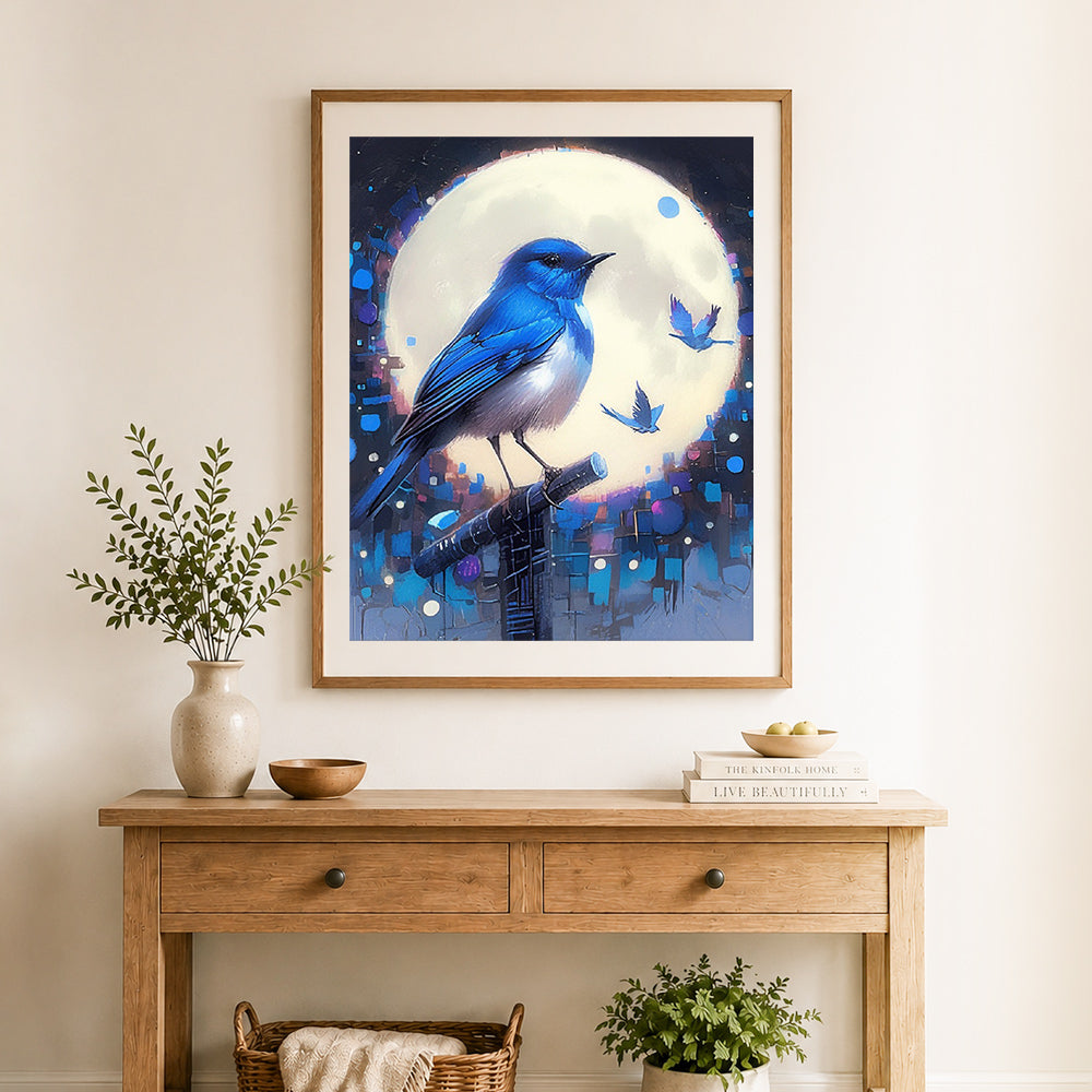 Finished blue bird bathed in moonlight cross stitch artwork displayed as home decor