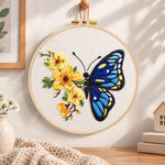 Blue butterfly with yellow blooms embroidery hoop wall art displayed as warm and cozy handmade home decor