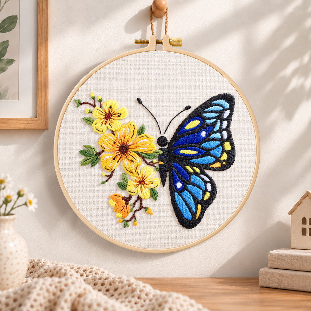 Blue butterfly with yellow blooms embroidery hoop wall art displayed as warm and cozy handmade home decor