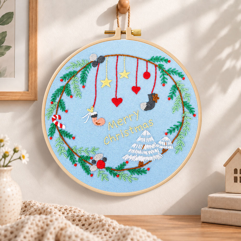 Blue christmas wreath embroidery hoop wall art displayed as warm and cozy handmade home decor