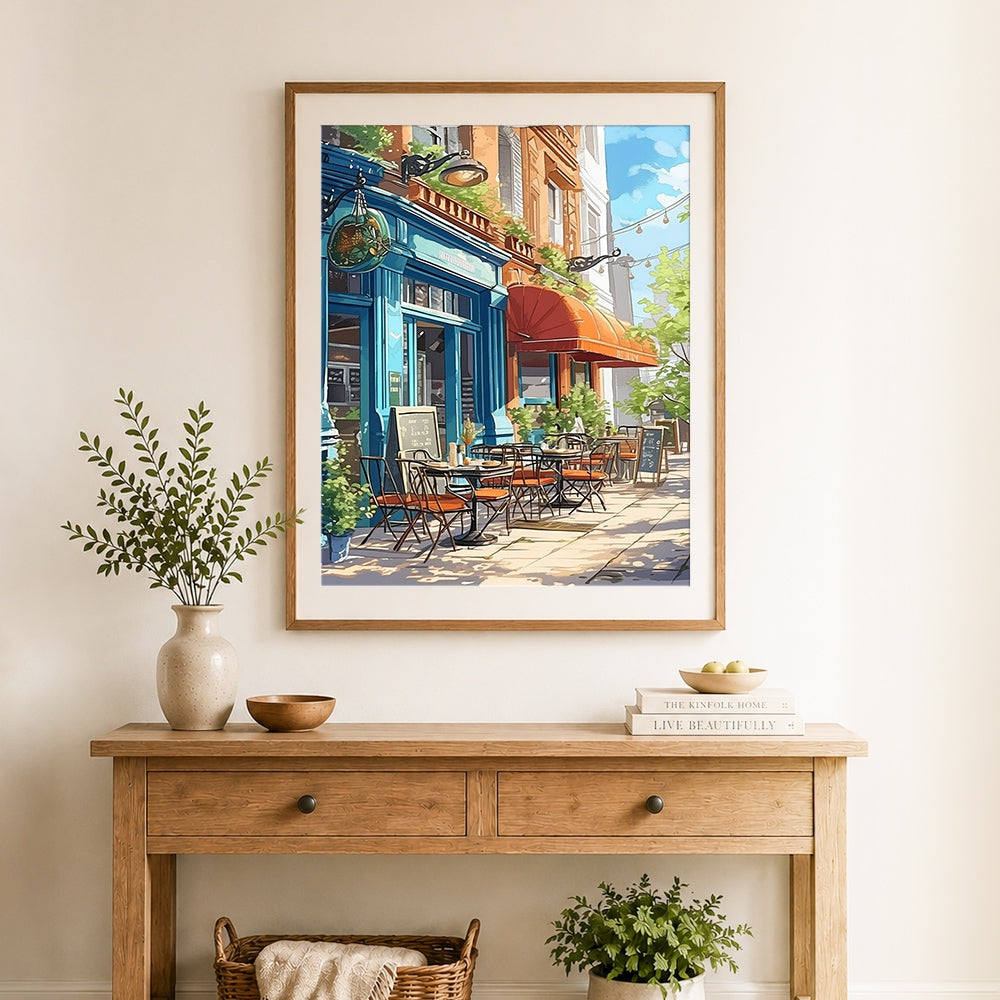 Finished blue corner cafe with red awning cross stitch artwork displayed as home decor