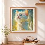 Finished blue-eyed white cat cross stitch artwork displayed as home decor