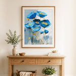 Finished blue poppies with gold centers cross stitch artwork displayed as home decor