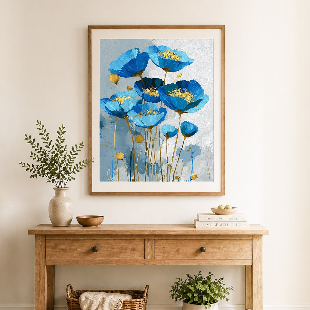 Finished blue poppies with gold centers cross stitch artwork displayed as home decor